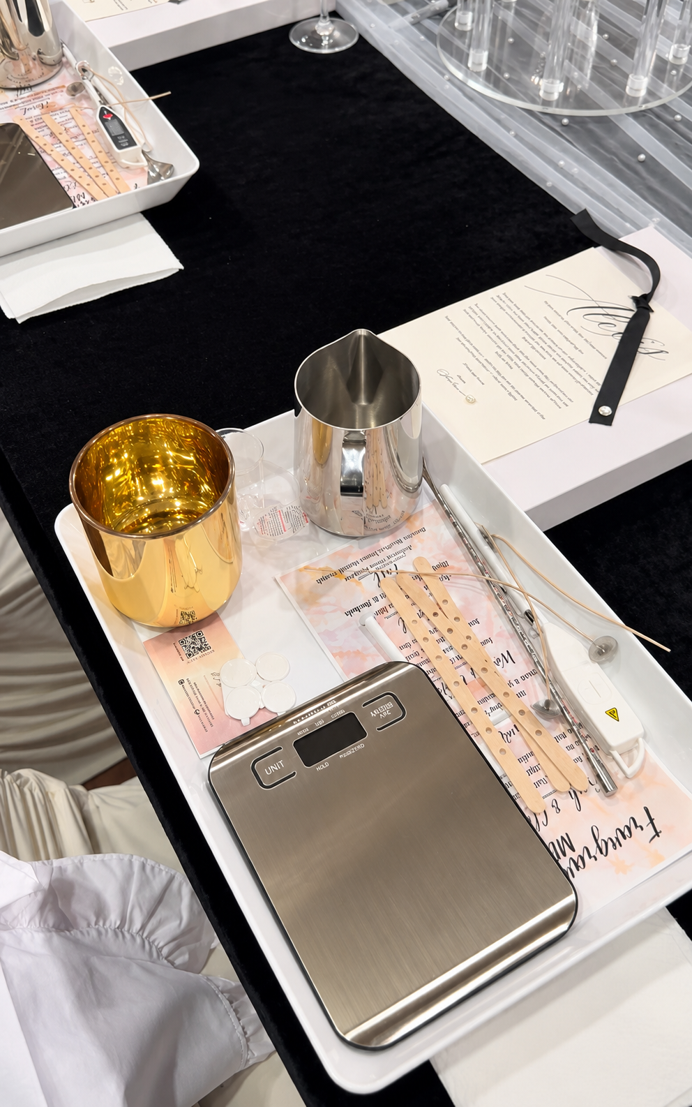 Individual candle-making workstation with a scale, fragrance guide, and pouring supplies